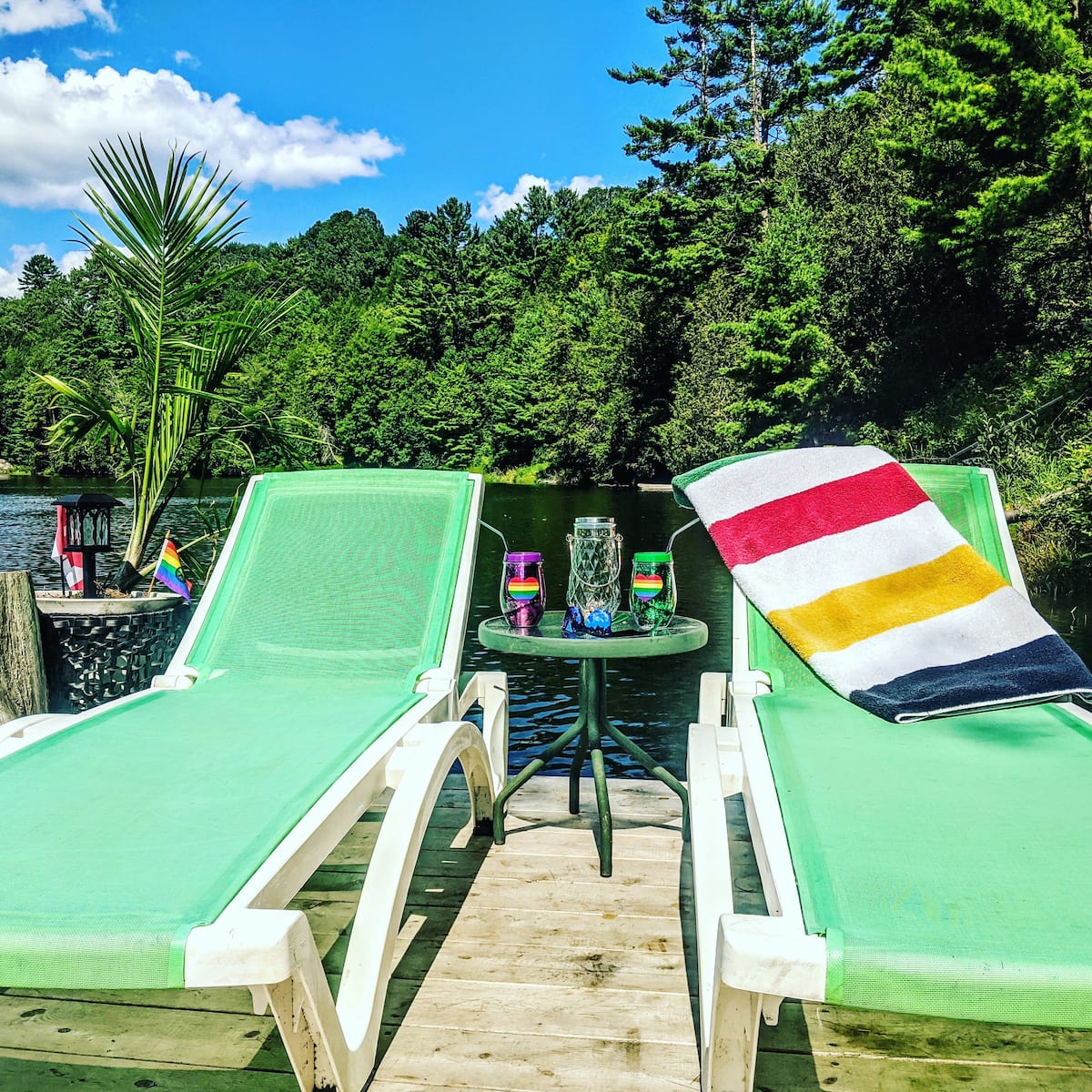 Lounge chairs on the dock at The Muskoka River Chalet overlooking the lake