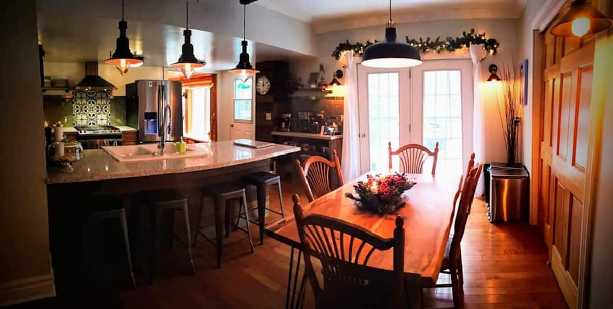 Open-concept kitchen at The Muskoka River Chalet with granite island and pendant lighting